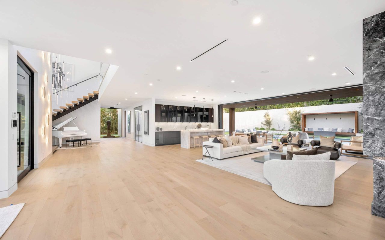 Wide, empty interior with a continuous wood floor.