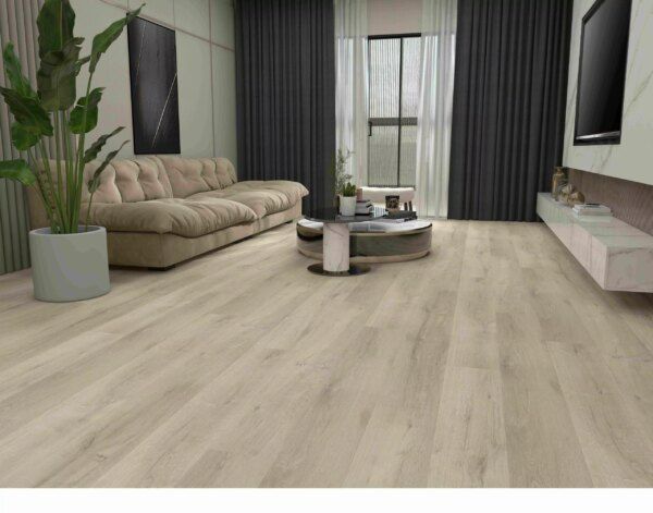 Living room with pale grey-white luxury vinyl tile planks, a beige sofa and tall plant